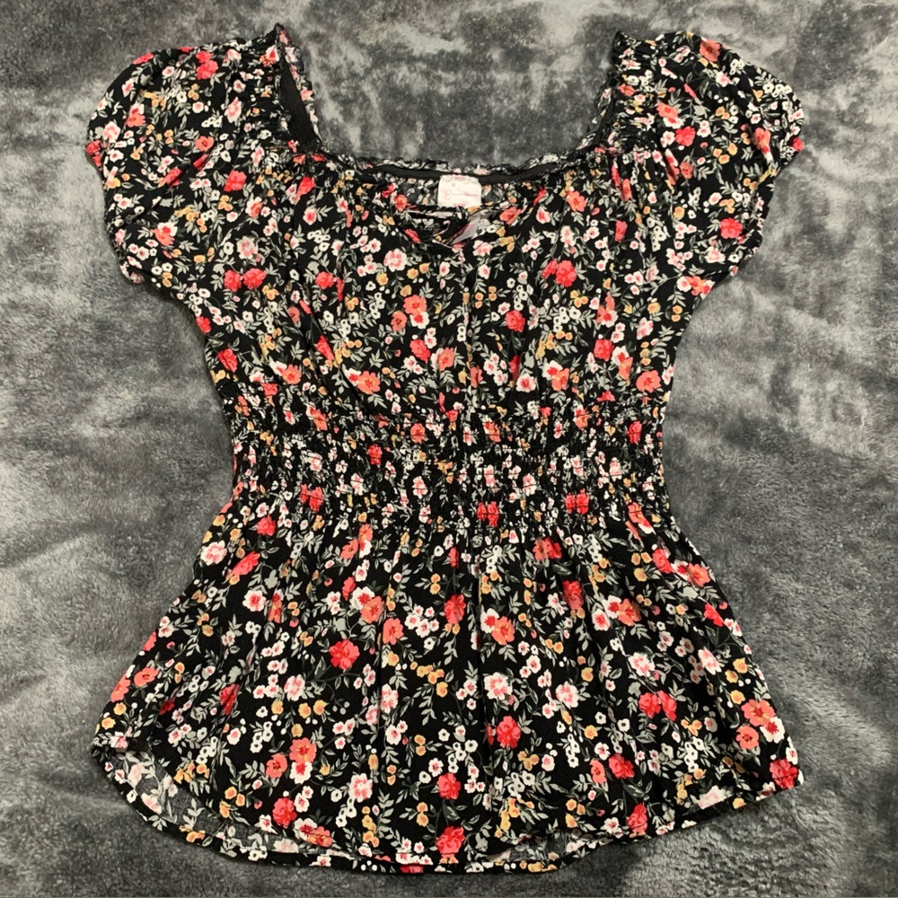 Black floral frilled top in the size small